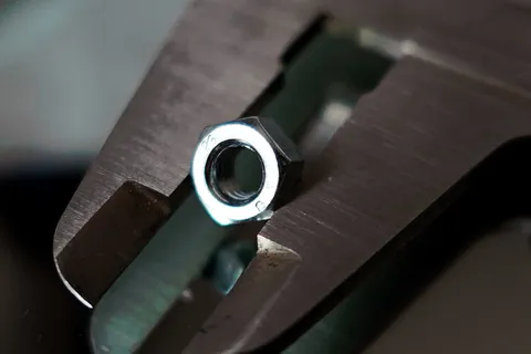 Measuring a manufactured nut using a set of Vernier callipers.