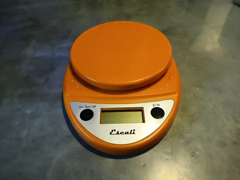 Weighing apples using digital scales.