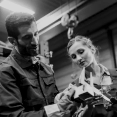 Young woman and man taking measurements with calipers.