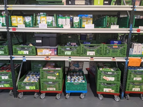 Shelves of food in a foodbank warehouse.